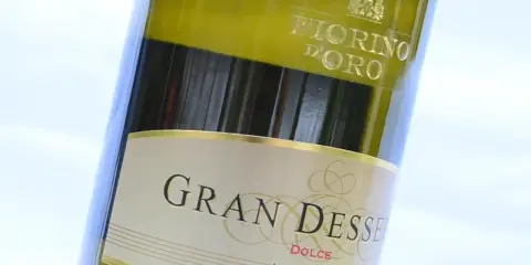 Close-up of a bottle of Gran Dessert Dolce wine, with "Fiorino D'Oro" visible at the top.